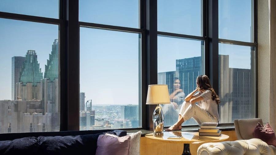 City skyline viewed through panoramic windows, reflecting travel experiences and destination discovery